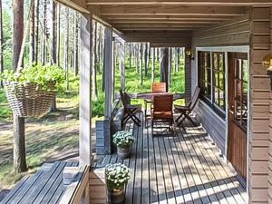 a porch of a house with a table and chairs at Holiday Home Kitkaranta by Interhome in Kitka