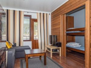 a living room with a couch and a bunk bed at Holiday Home Villa ylläs 201 by Interhome in Ylläs