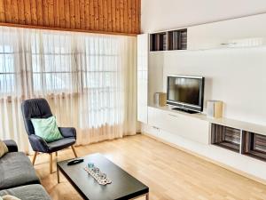 a living room with a couch and a tv at Apartment Diana by Interhome in Münster