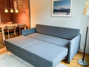 a couch sitting in a living room with a table at Holiday Home Ylläs chalets a307 by Interhome in Ylläs
