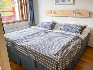 a bedroom with two beds with pillows and a window at Holiday Home Ylläs chalets a307 by Interhome in Ylläs +6 photos