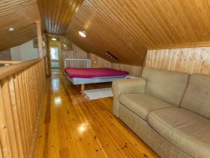 a living room with a couch and a bed at Holiday Home Meritähti by Interhome in Matildedal