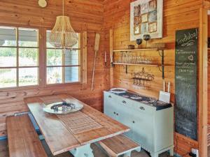 a kitchen with a table and a stove and a chalkboard at Holiday Home Annas beach by Interhome in Haminankylä