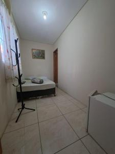 a room with a bed and a television in it at Hotel Padre Vitor in Aparecida +3 photos
