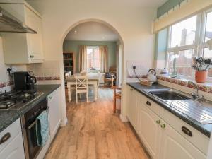 a kitchen with a sink and a counter top at Sandy Cove in Chathill