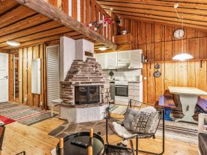 a living room with a stone fireplace in a house at Holiday Home Luppokero 2 by Interhome in Pyhätunturi
