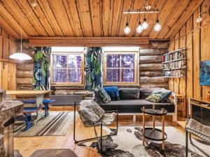 a living room with a couch and a table at Holiday Home Luppokero 2 by Interhome in Pyhätunturi