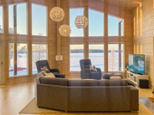 a living room with a couch and a tv at Holiday Home Leinola by Interhome in Sotkamo +28 photos