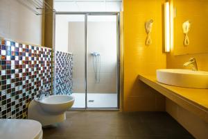 a bathroom with a shower and a toilet and a sink at Apartamentos San Francisco in San Antonio +19 photos