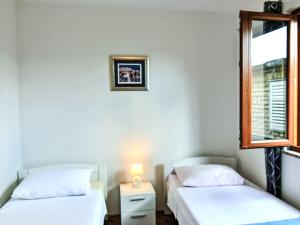 two beds in a room with a window at Holiday Home Marija by Interhome in Rovanjska