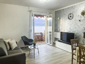a living room with a couch and a television at Apartment Daniela by Interhome in Dorio
