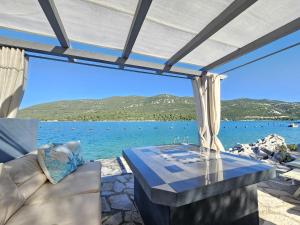 a patio with a table and a view of the water at Apartment Waterfront Oasis-3 by Interhome in Mali Ston +27 photos