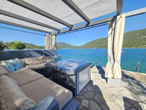 a living room with a couch and a view of the water at Apartment Waterfront Oasis-1 by Interhome in Mali Ston