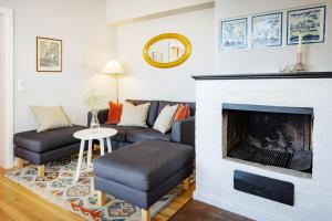 a living room with a couch and a fireplace at Brauhaus am See in Gartow