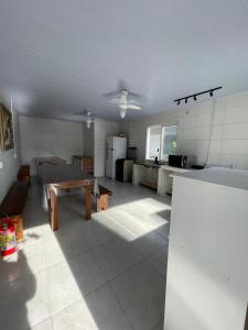 a large room with a kitchen and a table in it at Morá 2 Coliving in Cachoeirinha