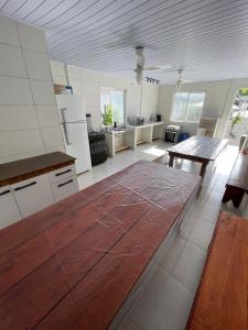 a large kitchen with white appliances and a wooden floor at Morá 2 Coliving in Cachoeirinha