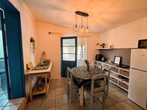 a kitchen with a table and a refrigerator at Buffelsrivier Farm Stay in Laingsburg