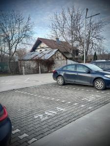 a blue car parked in a parking lot at VerdeViu Apartments 2 Prima Green Residence in Oradea