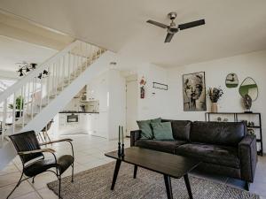 a living room with a couch and a table at Apartment Oostergeest 2 by Interhome in Uitgeest