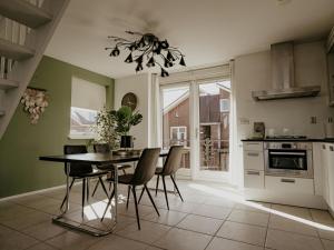 a kitchen with a dining room table and chairs at Apartment Oostergeest 2 by Interhome in Uitgeest