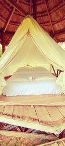a bed in a tent with a bowl on it at BOLAVEN GARDEN Bungalow and tent - Tad Lo in Ban Kiangtat