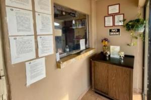 a restaurant with a counter and a mirror on the wall at Golden Inn Dallas by Hotel O in Dallas