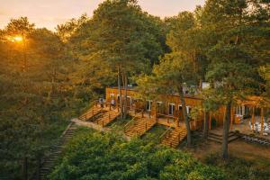 an aerial view of a house in the woods at Apartamenty Leśna Przystań nad jeziorem in Węgorzewo