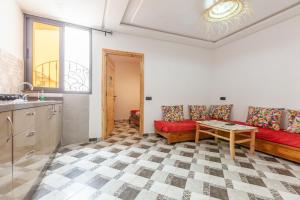 a living room with a red couch and a table at summer house berber in Tamraght Ouzdar