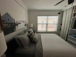 a white bedroom with a bed and a window at Beachside One Bedroom Condo with Pool Access in Hollywood