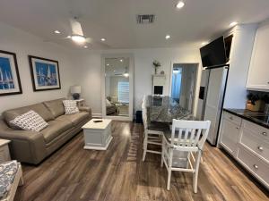 a living room with a couch and a table at Beachside One Bedroom Condo with Pool Access in Hollywood