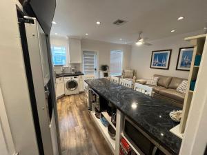 a kitchen and living room with a washer and dryer at Beachside One Bedroom Condo with Pool Access in Hollywood +7 photos