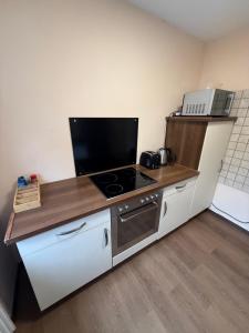 a kitchen with a stove and a counter top at Monteurpension Haus Monika in Marktheidenfeld