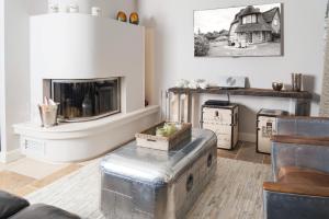 a living room filled with furniture and a fireplace at Rantum Lodge in Rantum