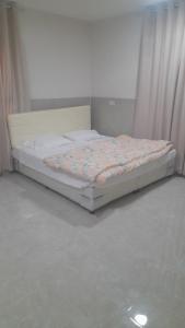a bed sitting in a room with a mattress at Room Quriyat in Ramlah