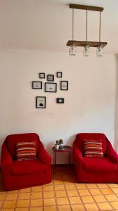 two red couches in a living room with a table at A casa di Filo in Boiano
