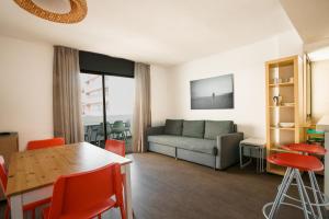 a living room with a couch and a table at Apartamentos San Francisco in San Antonio