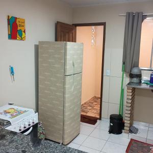 a kitchen with a stainless steel refrigerator in a room at Paim`s Village Itacaré in Itacaré