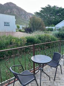 a patio with a table and chairs on a balcony at Kasteelberg View in Riebeek-Wes