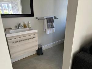 a bathroom with a sink and a mirror at Kasteelberg View in Riebeek-Wes