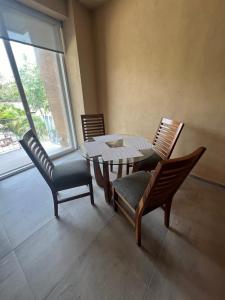 a dining room with a table and chairs and a window at Mangle09 in Puerto Vallarta