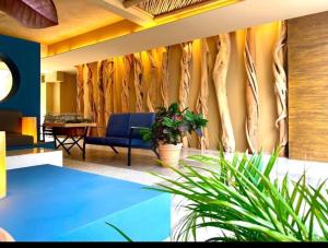 a living room with a wall of tree branches at Mangle09 in Puerto Vallarta +2 photos