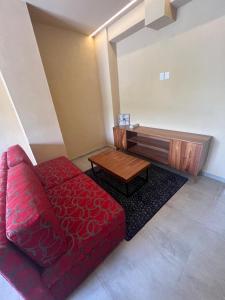 a living room with a red couch and a table at Mangle09 in Puerto Vallarta