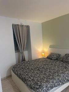 a bedroom with a bed and a window at nid douillet in La Roche-Posay