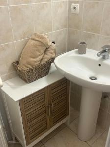 a bathroom with a sink and a basket on a counter at nid douillet in La Roche-Posay