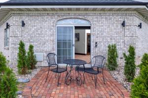 a patio with two chairs and a table in front of a building at Hotel J Green Bay in Green Bay