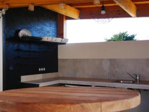 a kitchen with a counter top and a sink at Loc' Maria - Grands Sables in Groix