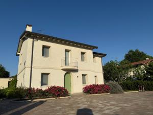 a large white building with a balcony and flowers at Ca' Maggiolo in Cinto Caomaggiore