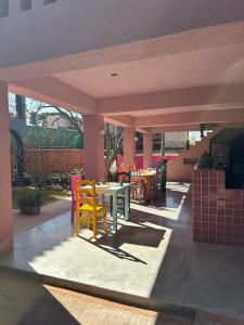 a patio with colorful chairs and tables in a restaurant at La Betulia Bed and Breakfast in Oaxaca City