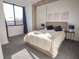 a bedroom with a large bed and a large window at Woolston Central 2-Bedroom Apartment in Warrington