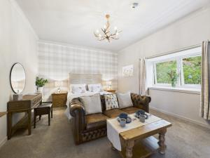 a living room with a couch and a bed at Glenshee Suite, Beechtree Cottage in Kirkmichael